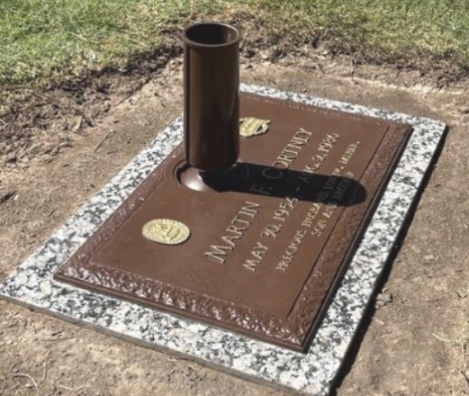 Martin's headstone after restoration — bronze plaque renewed